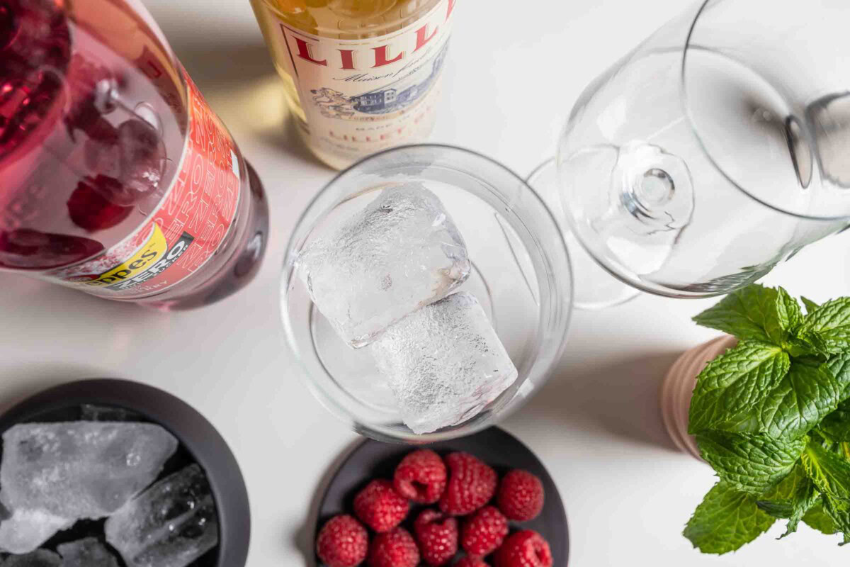 Eiswürfel in ein Glas füllen – Zutaten für Lillet Wild Berry im Bild