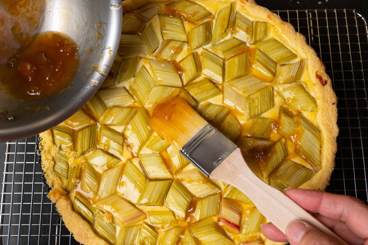 Rhabarber-Tarte wird mit Aprikosenglasur bestrichen